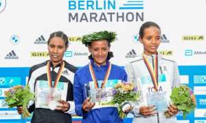 (From left) Ethiopia's Hiwot Gebrekidan, winner Gotytom Gebreslase and Helen Tola on the podium of the women's Berlin Marathon. By Tobias SCHWARZ (AFP)
