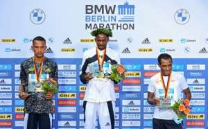 (From left) Kenya's Bethwel Yegon, winner Guye Adola and Kenenisa Bekele on the podium for the men's Berlin Marathon. By Tobias SCHWARZ (AFP)