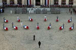 France's President Emmanuel Macron stands in front of the coffins of 13 French soldiers killed in action in Mali last November. By Eliot BLONDET (POOL/AFP)