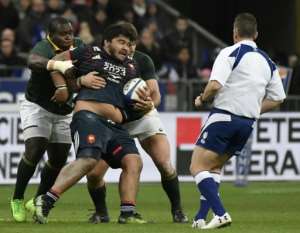 France's prop SÃ©bastien Taofifenua (C) is tackled during their match against South Africa's Springboks in Saint-Denis, on the outskirts of Paris, on November 18, 2017