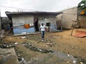 François Bakakeu walks by his home following flood damage in July. By Adrien MAROTTE (AFP)