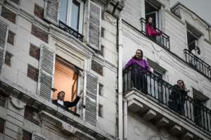 French opera tenor singer Stephane Senechal performs 'O Sole Mio' from his window in Paris on the tenth day of a strict lockdown in France. By PHILIPPE LOPEZ (AFP)