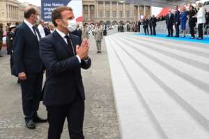 French President Emmanuel Macron, who oversaw drastically downsized Bastille Day celebrations due to the coronavirus, said he would like to make masks mandatory in enclosed public spaces. By Ludovic Marin (POOL/AFP)