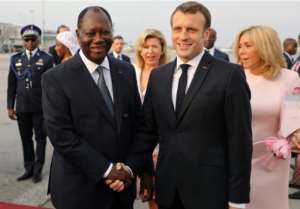 French President Emmanuel Macron and his wife Brigitte were greeted by Ivorian President Alassane Ouattara. By LUDOVIC MARIN (AFP)