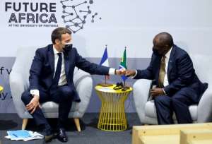 French President Emmanuel Macron, left, is backing the technology transfer initiative along with South Africa's Cyril Ramaphosa. By Ludovic MARIN (AFP/File)