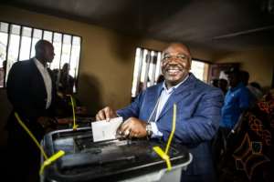 Gabonese President Ali Bongo Ondimba arrives to cast his vote at a polling station during the presidential election, which he won by fewer than 6,000 votes