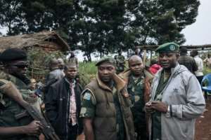 General Germain Katanga, centre, takes part in a meeting with CODECO militiamen in Masumbuko. By ALEXIS HUGUET (AFP)