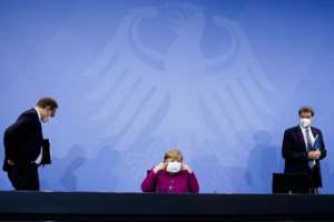 German Chancellor Angela Merkel (C), Bavaria's State Premier Markus Soeder (R) and Berlin's Mayor Michael Mueller leave following talks with Germany's state premiers on the extension of the current Covid-19 restrictions in Berlin March 4, 2021. By Markus Schreiber (POOL/AFP)