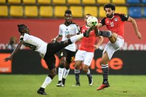 Ghana's defender Harrison Afful (L) challenges Egypt's forward Mohamed Salah during the 2017 Africa Cup of nations January 25, 2017