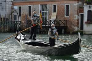 Gondoliers returned to the canals of Venice, even if they are now wearing masks and gloves. By ANDREA PATTARO (AFP)