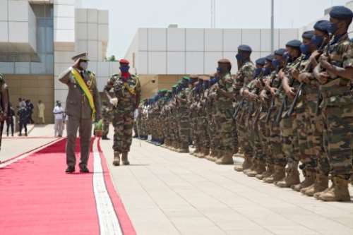 Goita salutes members of Mali's armed forces after being sworn in as transitional president.  By ANNIE RISEMBERG (AFP)