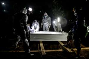 Gravediggers work during a funeral for a COVID-19 victim in Bogor, Indonesia.. By ADITYA AJI (AFP)