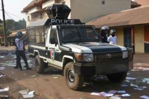 Guinean police officers guarded voting stations where protesters destroyed ballot papers. By CELLOU BINANI (AFP)