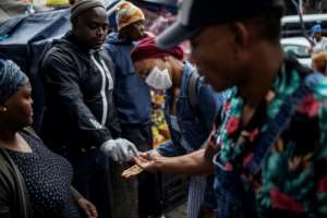 Hand hygiene at a taxi rank in Johannesburg: The government has been urging the public to brake the feared surge in coronavirus cases with simple prevention. By Michele Spatari (AFP)