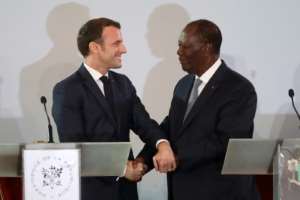Handshake: Macron and Ouattara at their press conference in Abidjan last Saturday. By Ludovic MARIN (AFP)