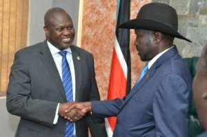 Handshake: President Salva Kiir, right, and ex-vice president and former rebel leader Riek Machar at their meeting on Wednesday. By AKUOT CHOL (AFP)