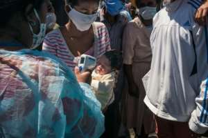 Health workers took temperatures of the passengers before boarding. By RIJASOLO (AFP)