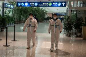 Health workers were waiting to meet the WHO team as they arrived in Wuhan on Thursday ahead of their probe into the origins of the pandemic. By NICOLAS ASFOURI (AFP)
