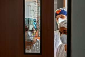 Health workers check on a COVID-19 patient at the Intensive Care Unit of the General Hospital, in Medellin, Colombia. By JOAQUIN SARMIENTO (AFP)