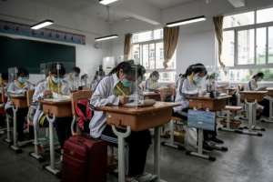 High school senior students study with plastic partitions in a classroom in Wuhan in China's central Hubei province. By STR (AFP)