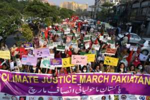 Human rights activists hold placards in Lahore on November 8 during a protest in connection with the COP26 UN Climate Change Conference. By Arif ALI (AFP/File)