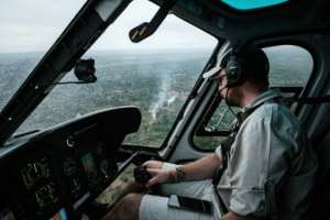 Hunter: Helicopters are sent out to spot swarms in the early morning as the locusts are roosting in trees and bushes. Pilots then call in pesticide-spraying aircraft to kill the insects. By Yasuyoshi CHIBA (AFP)