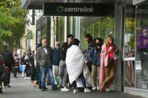 Hundreds of people queue outside a government welfare centre, Centrelink, in Melbourne on March 23, 2020, as jobless Australians flood unemployment offices. By William WEST (AFP/File)