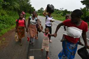 Hundreds of residents could be seen fleeing the area on foot, wearing backpacks or carrying sacks of belongings on their heads. By Issouf SANOGO (AFP)