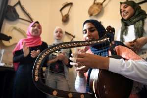 Iman Haddo (C), a 20-year-old musician, says she instantly fell in love with the semsemia when she was a teenager after attending a local concert with her father.. By Khaled DESOUKI (AFP)