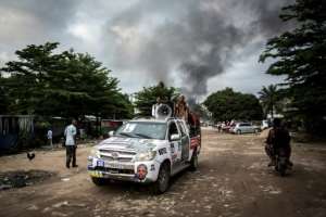 In the early hours of Thursday, arsonists hit a large electoral commission warehouse in central Kinshasa, setting it ablaze and damaging election materials. By John WESSELS (AFP)