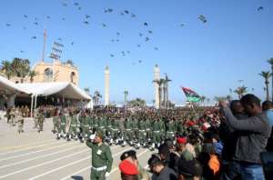 In the Libyan capital Tripoli, under the control of the Turkish-backed Government of National Accord (GNA), soldiers opposed to Haftar marched on Thursday to mark Libya's 69th anniversary of its independence. By Mahmud TURKIA (AFP)