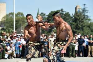 In this 2017 file photo members of the Algerian Special Forces demonstrate their martial arts skills during a parade marking the 55th anniversary of Algerian independence. By RYAD KRAMDI (RYAD KRAMDI/AFP/File)