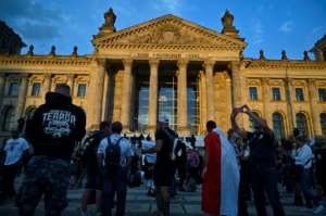 In Berlin, thousands protested against coronavirus restrictions but police later stopped the rally because many were not respecting social distancing measures. By John MACDOUGALL (AFP)