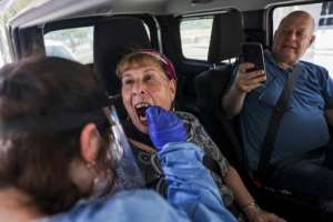 In Israel, where this woman is being tested for Covid-19, the government has authorized booster shots for those over the age of 60. By MENAHEM KAHANA (AFP)