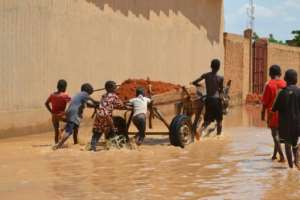 In Niamey, locals struggle to save what remains of the capital's hardest hit areas. By BOUREIMA HAMA (AFP)