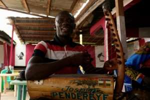 In revamping motenguene, the traditional kora instrument often gives way to the electric guitar. By Camille Laffont (AFP)