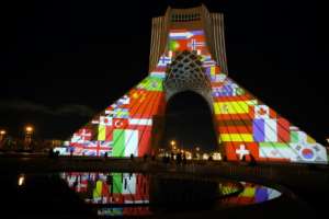 Iran's Azadi (Freedom) Tower is lit up with flags and messages of hope in solidarity with all the countries affected by the COVID-19 coronavirus pandemic. By STR (AFP)