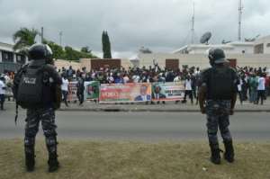 Ivorian police officers stand guard as supporters of Guillaume Soro submit his candidacy papers. By SIA KAMBOU (AFP)