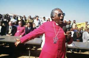 July 10, 1985: Tutu speaking at the funerals of four young anti-apartheid activists killed by hand grenades. By GIDEON MENDEL (AFP)