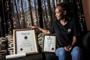 Kgomotso Sebabi, a South African unemployed graduate shows her higher education certificate. By GIANLUIGI GUERCIA (AFP)