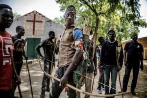 Land of Tensions: Hunters armed with bows and arrows gathered in Dbado, central Nigeria, in February, pledging to defend farmers in conflict with nomadic pastoralists. By Luis TATO (AFP)