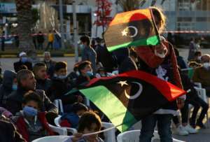 Libyan children wave national flags at an anniversary military parade in the Mediterranean port city of Tajura. By Mahmud TURKIA (AFP)