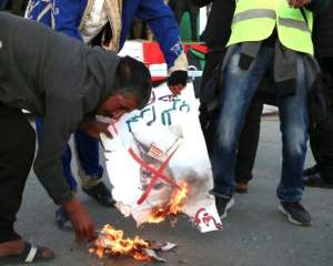 Libyans burn a picture of strongman Khalifa Haftar during a rally in support of the UN-recognised government in the capital Tripoli earlier this month. By - (AFP)
