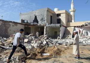 Libyans check the site of an air strike in which three children were killed and others wounded on the southern outskirts of Tripoli on October 14, 2019. By Mahmud TURKIA (AFP/File)