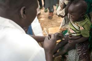 Life-saving: A child in Agang village gets the measles, mumps and rubella vaccine.  By Amaury HAUCHARD (AFP)