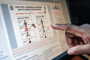 Like this: A staff member at Uganda's electoral commission points to a screen displaying how a ballot paper should be marked. By SUMY SADURNI (AFP)