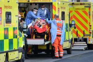 London ambulance staff stretcher a patient into the Royal London Hospital in the east of the city. By DANIEL LEAL-OLIVAS (AFP)