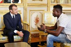 Mamoudou Gassama told French President Emmanuel Macron he 'did not think twice' before scaling a building to rescue the child.  By Thibault Camus (POOL/AFP/File)