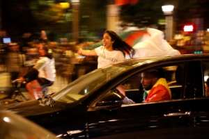 Many fans leaned precariously out of car windows as they waved red, white and green flags. By Zakaria ABDELKAFI (AFP)