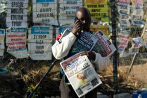 Man people in Harare were out working as normal Saturday, a day after the death of their former president. By Jekesai NJIKIZANA (AFP)